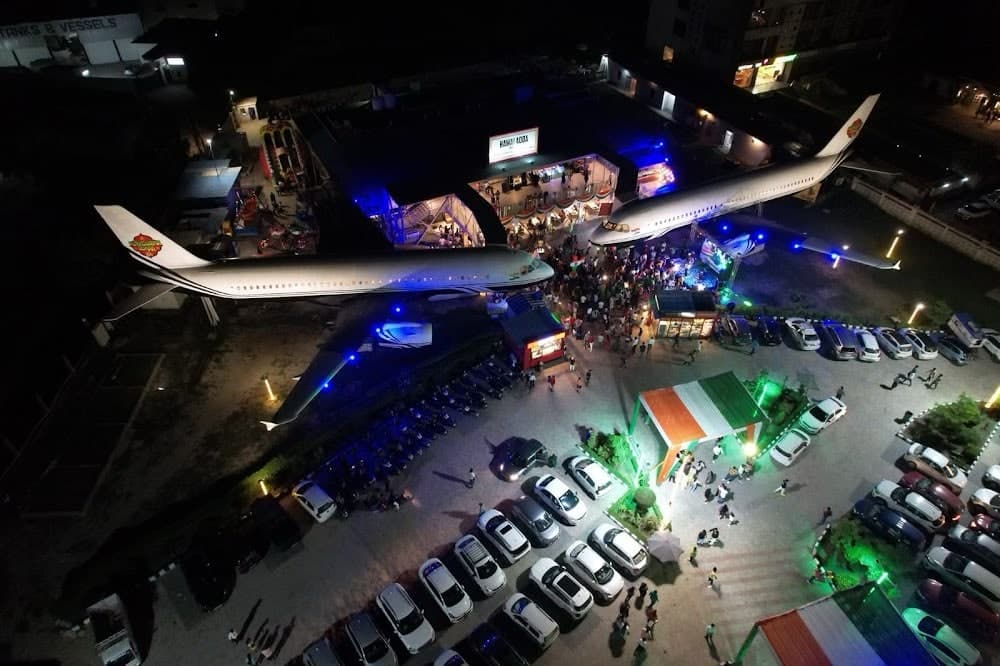 Aerial night view of the Hawai Adda aircraft fine-dining restaurant at Murthal, Sonipat, with cars parked around it