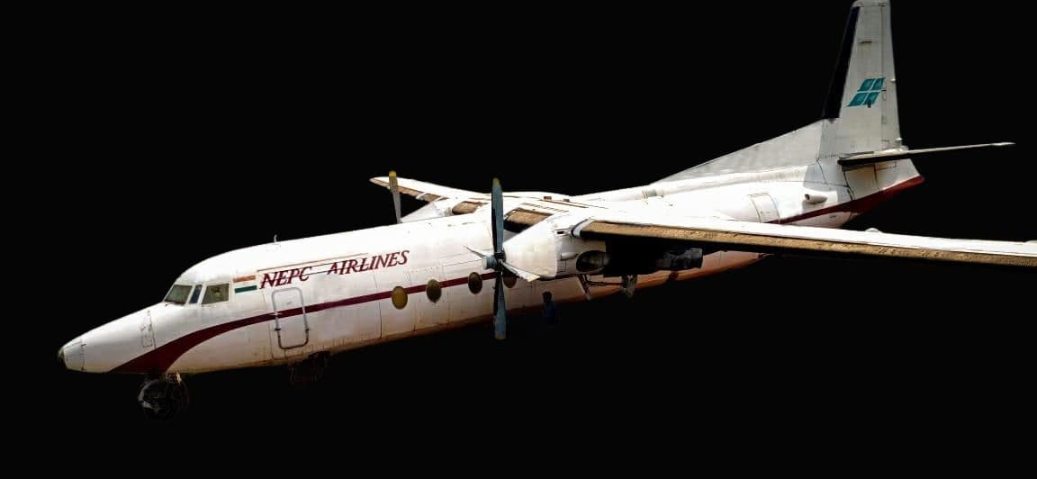 A NEPC Airlines Fokker F27 parked on a hilltop in Morni Hills, Haryana, with forested hills behind