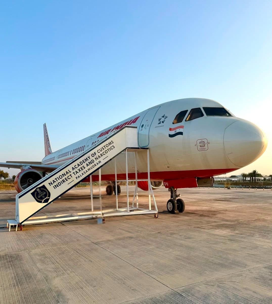 An Air India Airbus A320 converted into a training aircraft for NACIN, with branded boarding stairs, at Palasamudram